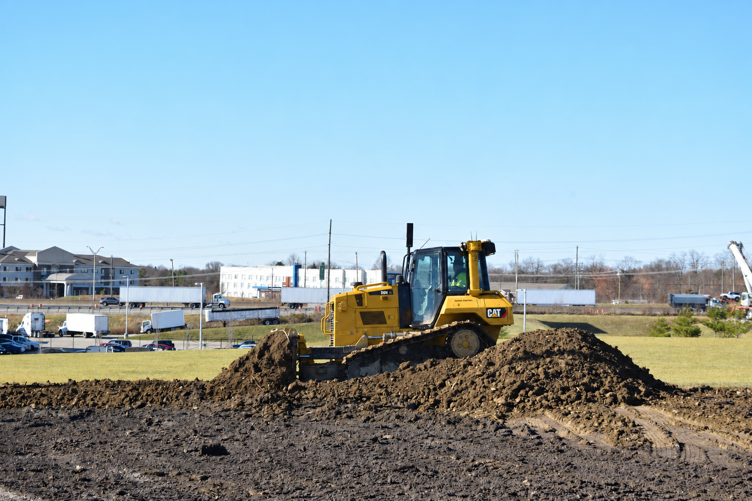 Caterpillar dozer pushing soil during civil earthworks